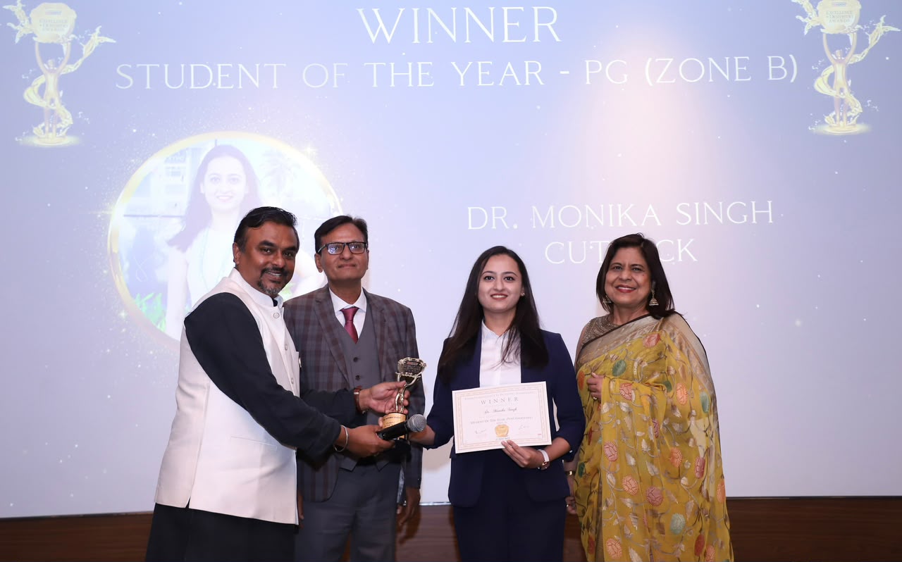 Dr. Monika Singh receiving the Famdent Student of the Year award on stage
