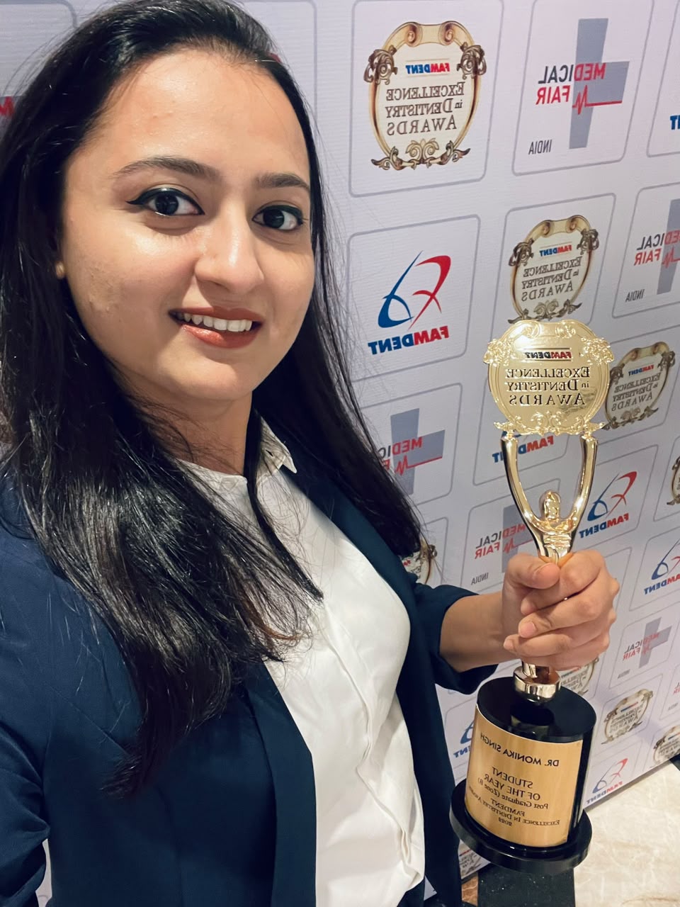 Dr. Monika Singh with the Famdent trophy